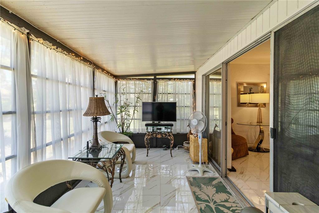672 White Pine Tree Road, Unit 57 Venice, FL 34285 - Photo 14 of 57 a living room with furniture and a flat screen tv