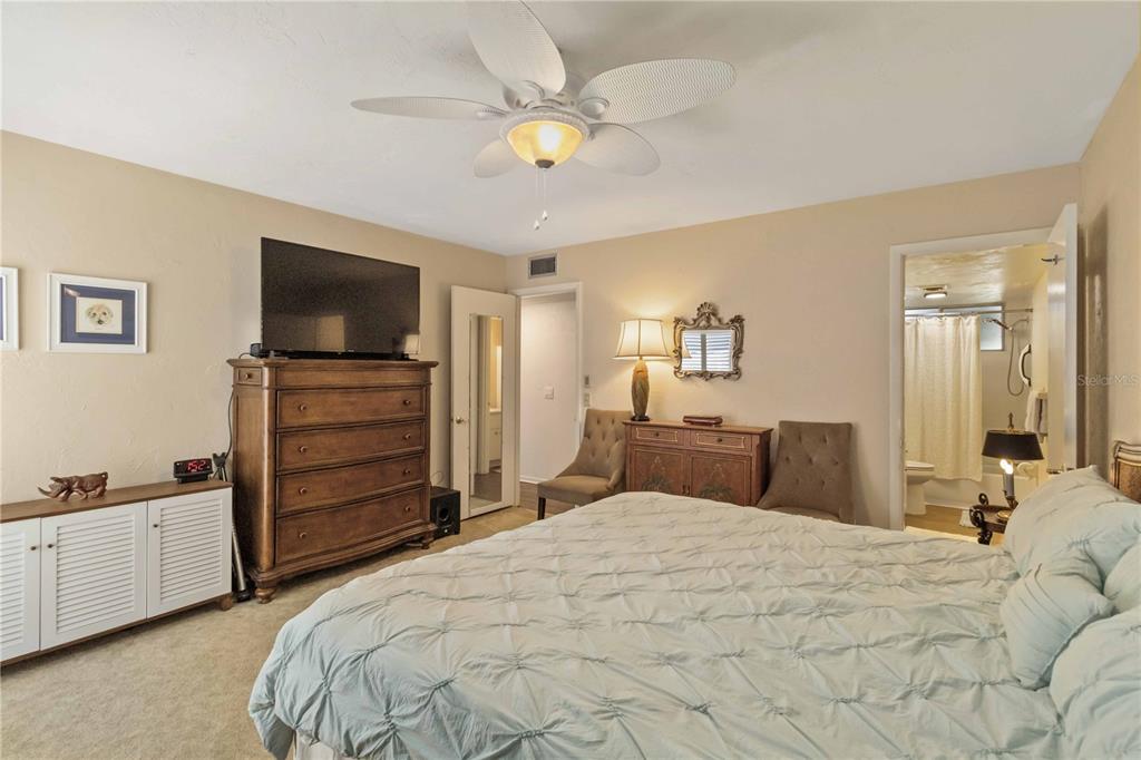 672 White Pine Tree Road, Unit 57 Venice, FL 34285 - Photo 17 of 57 a bedroom with a bed and a flat screen tv