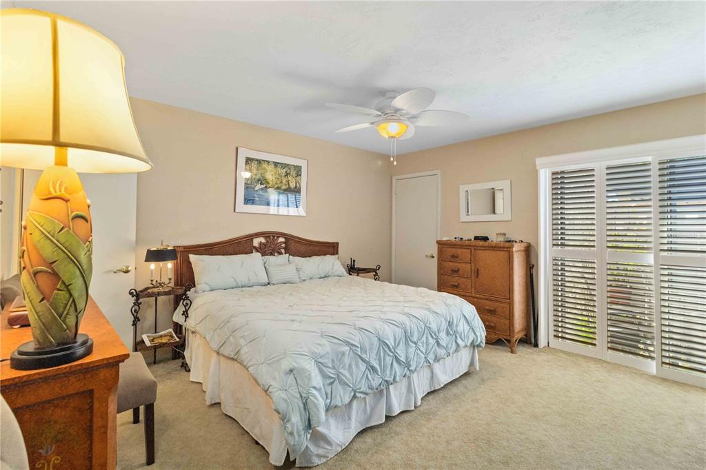 672 White Pine Tree Road, Unit 57 Venice, FL 34285 - Photo 18 of 57 a bedroom with a bed and a night stand