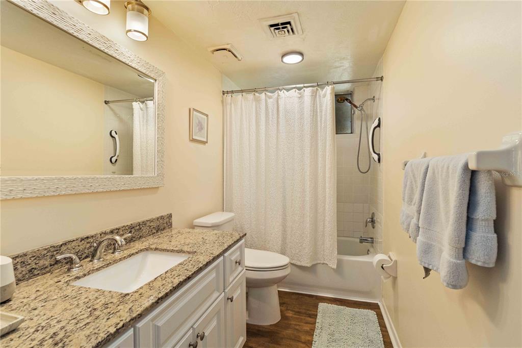 672 White Pine Tree Road, Unit 57 Venice, FL 34285 - Photo 19 of 57 a bathroom with a granite countertop sink and a mirror
