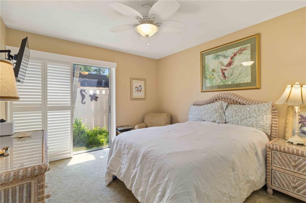 672 White Pine Tree Road, Unit 57 Venice, FL 34285 - Photo 21 of 57 a bedroom with a bed and a chandelier