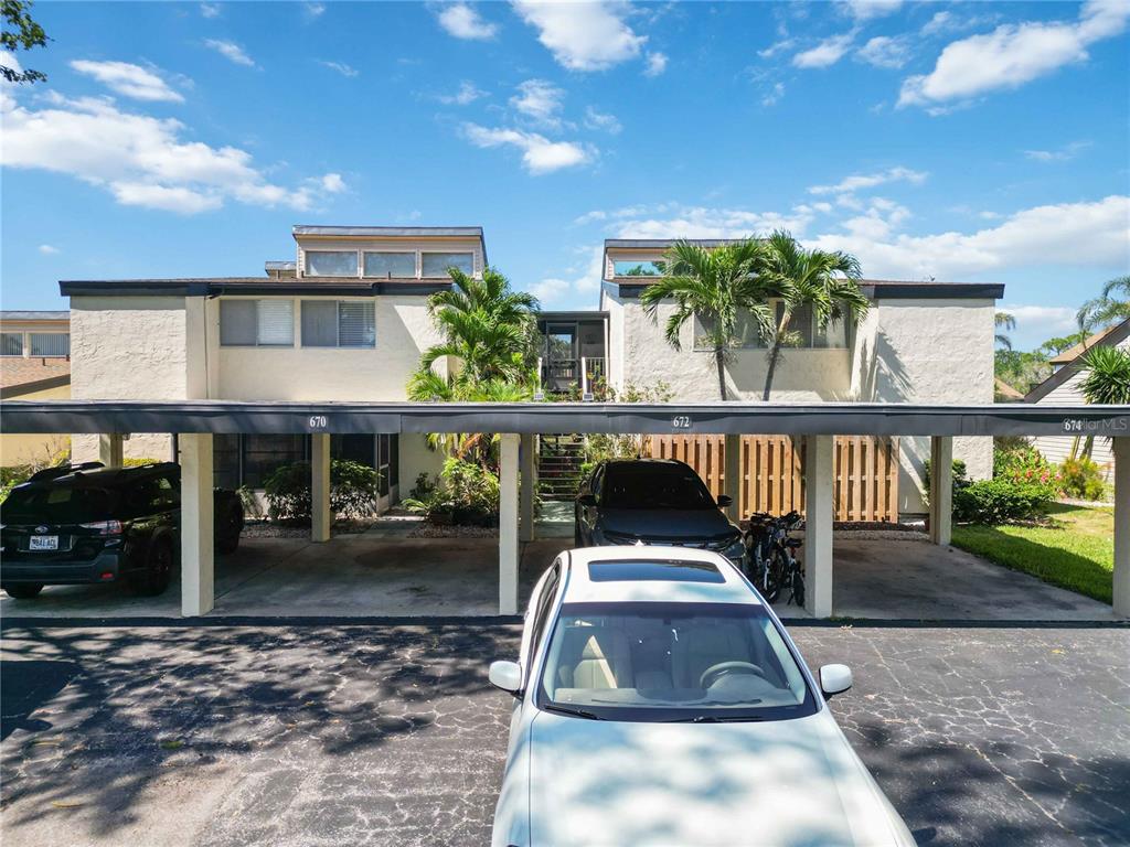 672 White Pine Tree Road, Unit 57 Venice, FL 34285 - Photo 29 of 57 a front view of a house with a yard