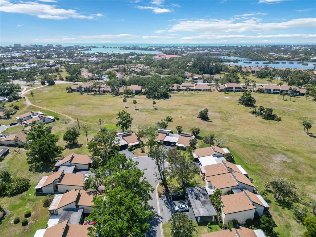 672 White Pine Tree Road, Unit 57 Venice, FL 34285 - Photo 32 of 57 an aerial view of residential houses with outdoor space