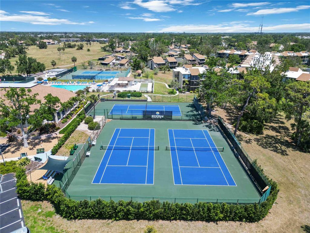 672 White Pine Tree Road, Unit 57 Venice, FL 34285 - Photo 49 of 57 an aerial view of residential houses with outdoor space