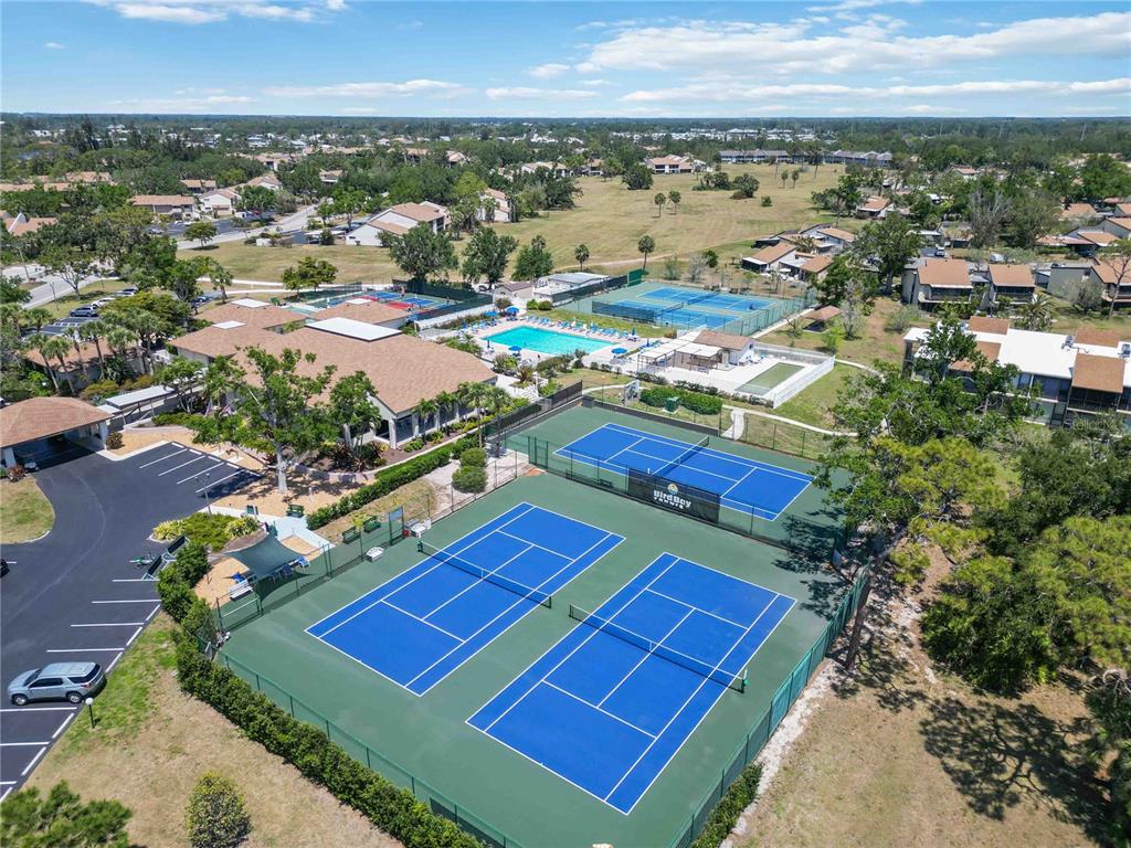 672 White Pine Tree Road, Unit 57 Venice, FL 34285 - Photo 50 of 57 an aerial view of tennis court