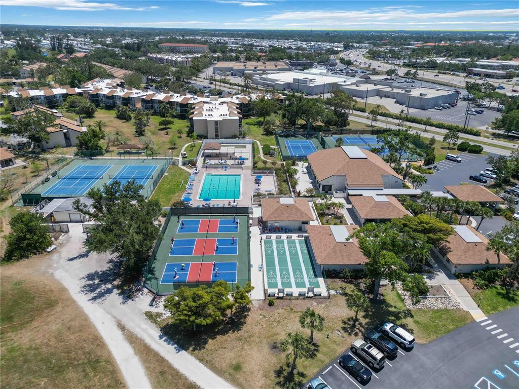 672 White Pine Tree Road, Unit 57 Venice, FL 34285 - Photo 51 of 57 an aerial view of residential houses with yard