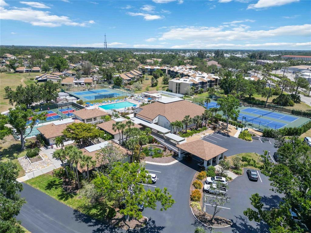 672 White Pine Tree Road, Unit 57 Venice, FL 34285 - Photo 55 of 57 an aerial view of residential houses with outdoor space