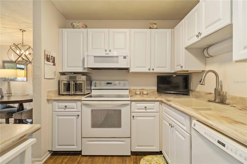 672 White Pine Tree Road, Unit 57 Venice, FL 34285 - Photo 10 of 57 a kitchen with appliances a sink and cabinets