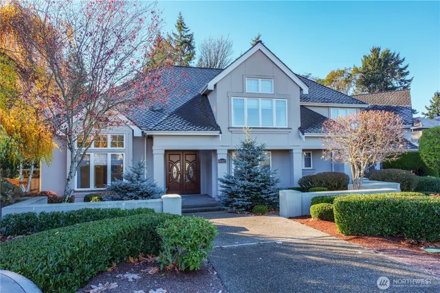 a front view of a house with a yard and potted plants