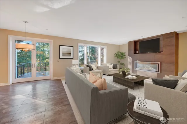 a living room with furniture a flat screen tv and a window