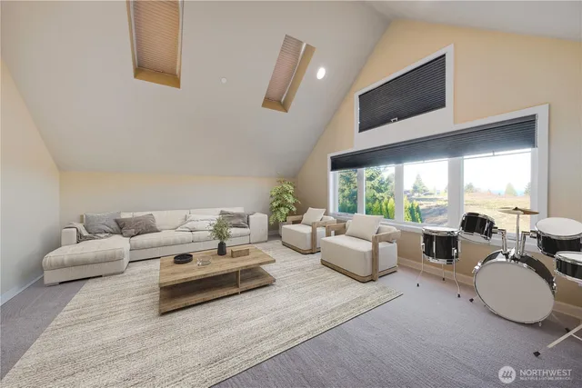a living room with furniture large window and a flat screen tv