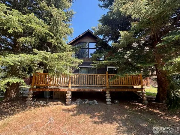 a view of a deck with a house and a yard