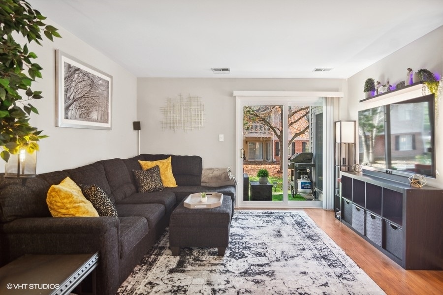 1345 East Evergreen Drive, Unit 3 Palatine, IL 60074 - Photo 3 of 13 a living room with furniture tv and a table