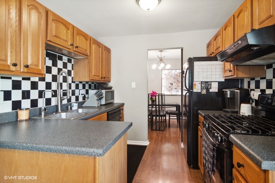 1345 East Evergreen Drive, Unit 3 Palatine, IL 60074 - Photo 5 of 13 a kitchen with stainless steel appliances granite countertop a stove and a refrigerator