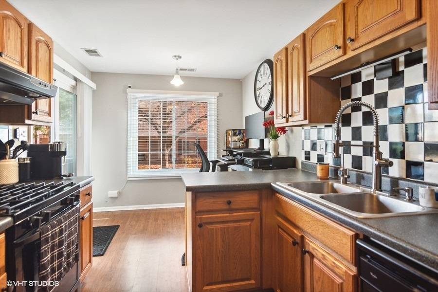 1345 East Evergreen Drive, Unit 3 Palatine, IL 60074 - Photo 6 of 13 a kitchen with stainless steel appliances a sink stove and cabinets