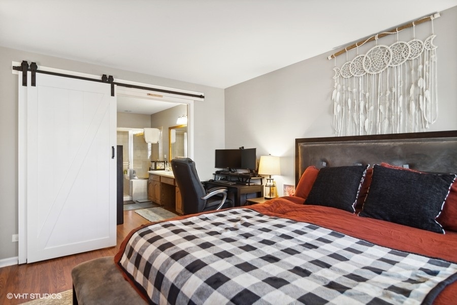 1345 East Evergreen Drive, Unit 3 Palatine, IL 60074 - Photo 9 of 13 a bedroom with a bed and wooden floor