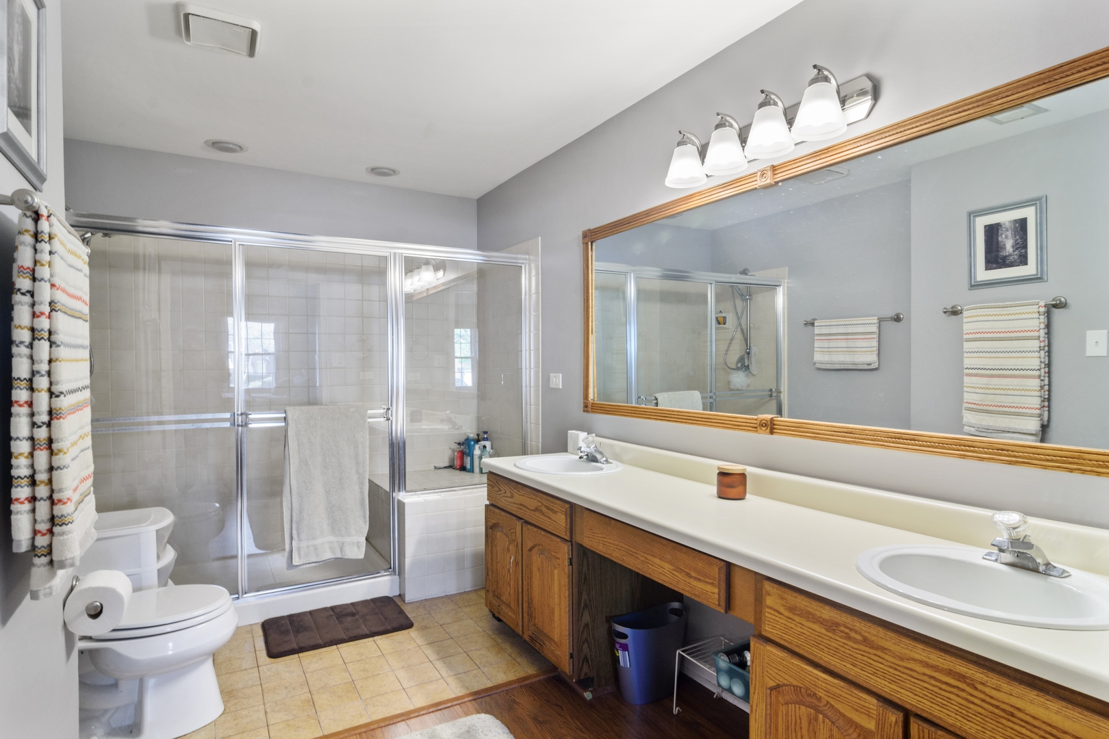 1345 East Evergreen Drive, Unit 3 Palatine, IL 60074 - Photo 10 of 13 a spacious bathroom with a double vanity sink toilet and a shower