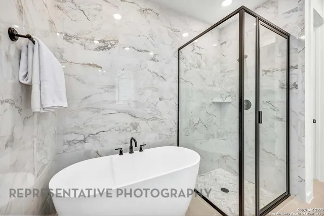 a bathroom with a bathtub and shower