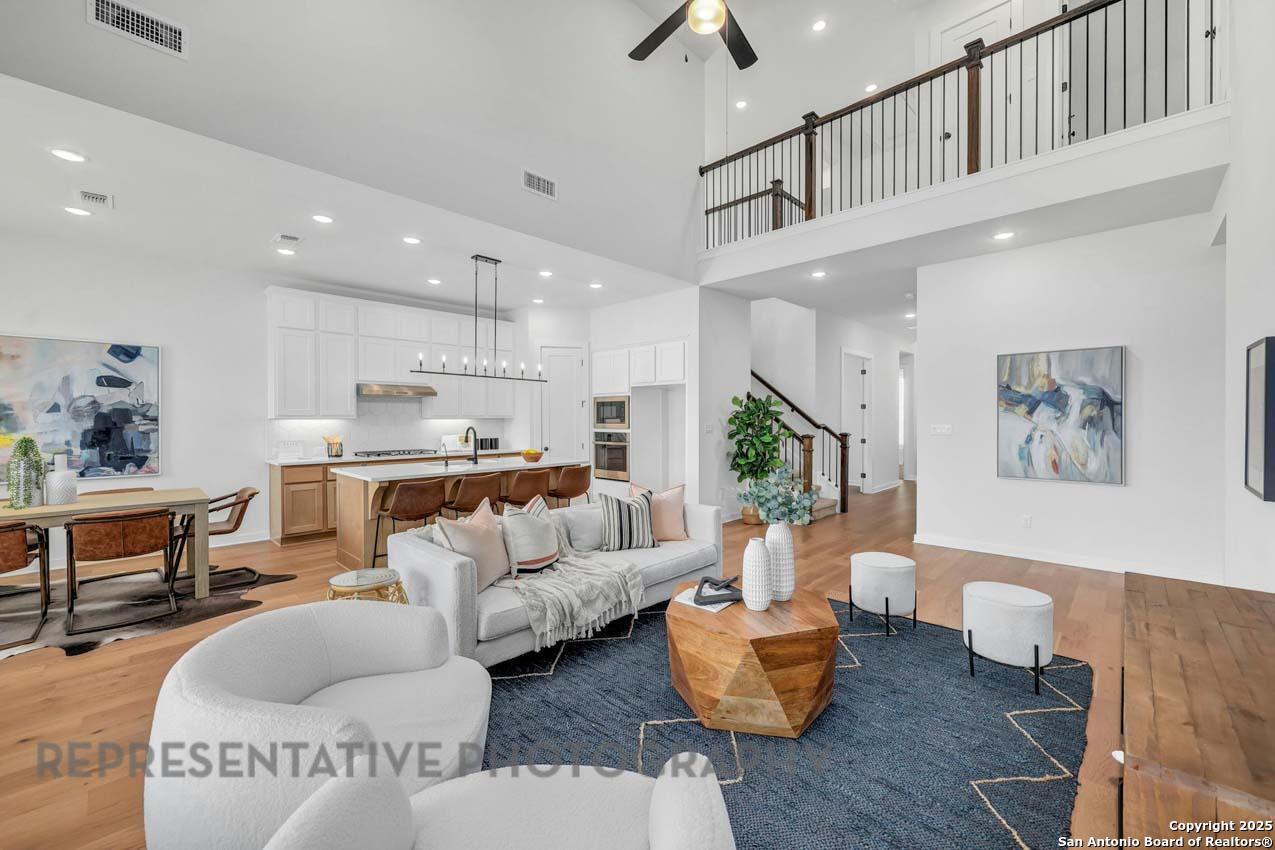 148 Spanish Oak Castroville, TX 78009 - Photo 6 of 19 a living room with furniture kitchen view and a chandelier