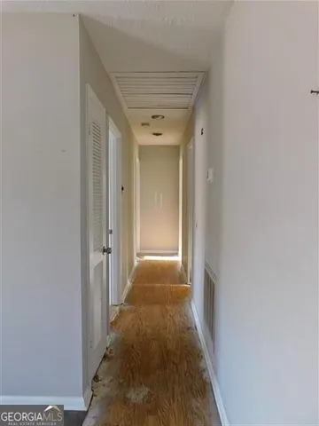 a view of a hallway with wooden floor