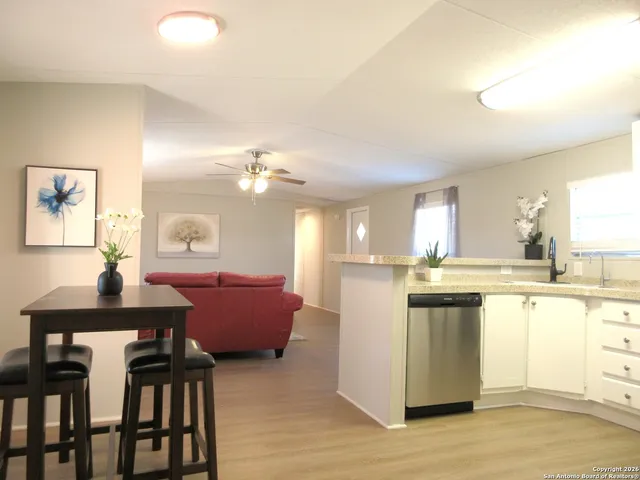 a kitchen with a table and chairs
