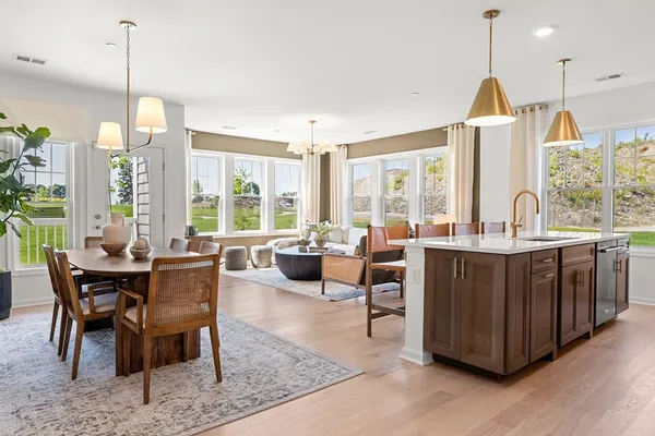 a dining room with furniture a chandelier and wooden floor
