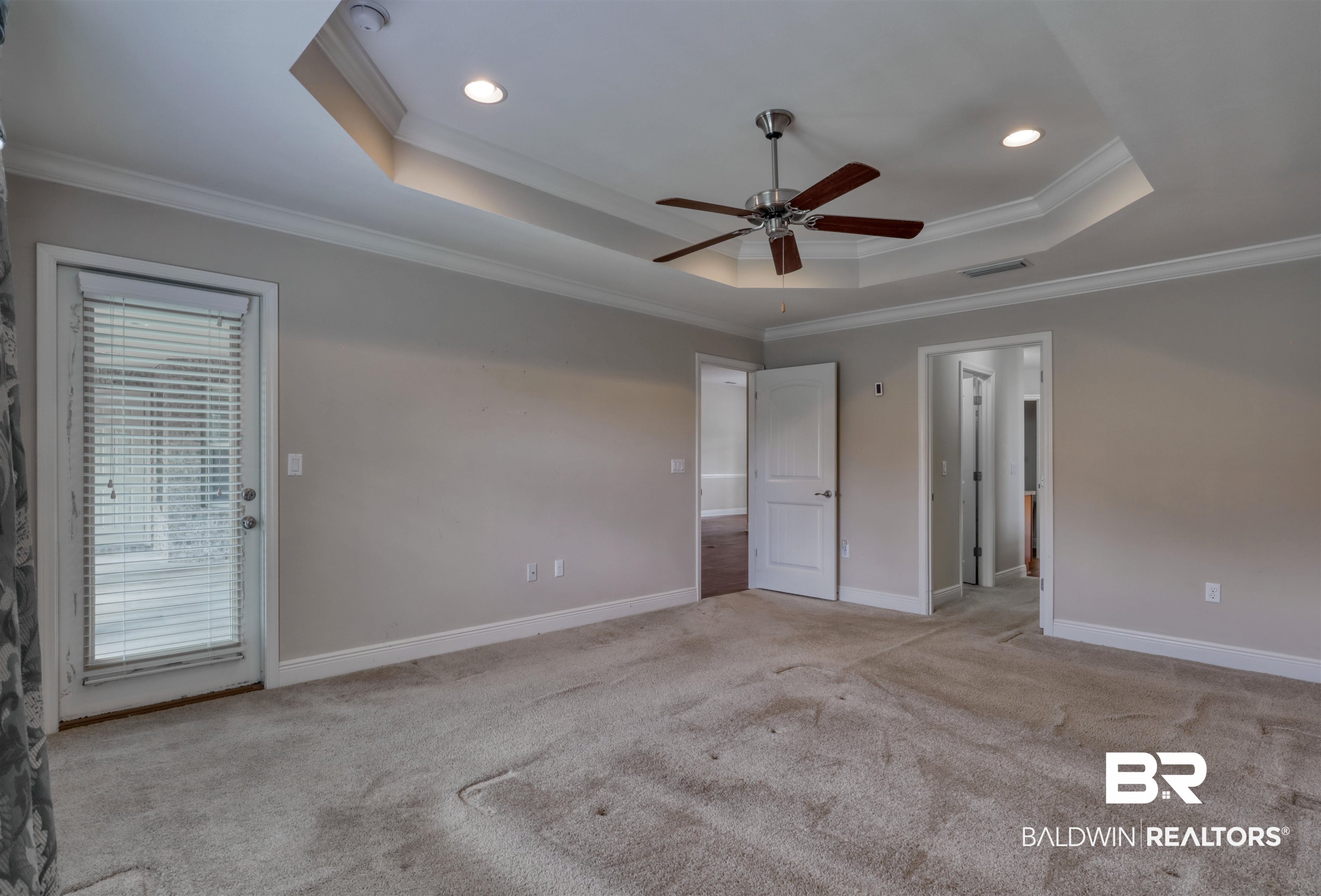 14794 Troon Drive Foley, AL 36535 - Photo 13 of 33 Unfurnished bedroom featuring visible vents, ornamental molding, a raised ceiling, and carpet flooring