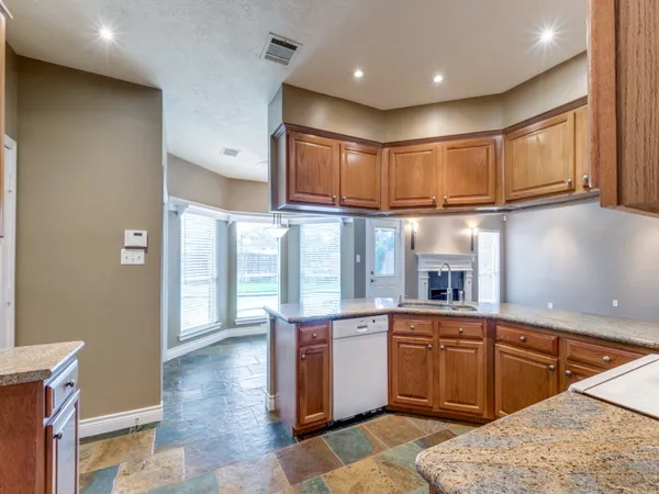 a kitchen with a sink stove and cabinets