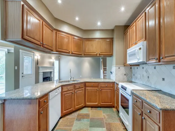 a kitchen with a sink cabinets and window
