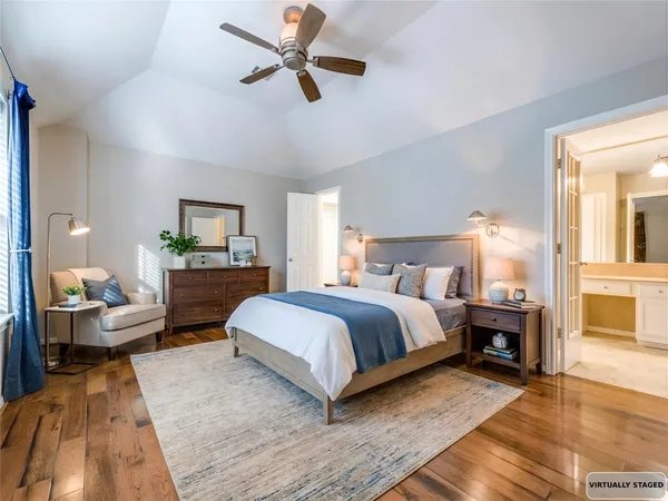 a bedroom with a large bed and a chandelier