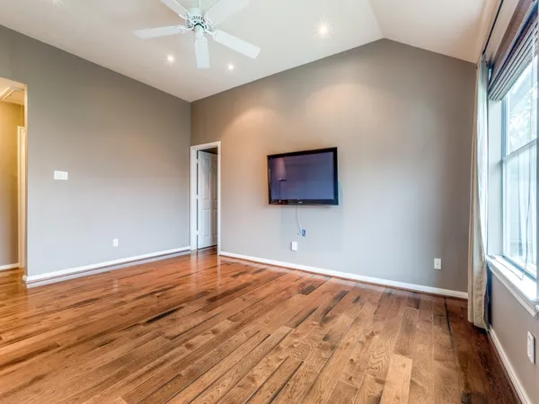 wooden floor in an empty room with a window