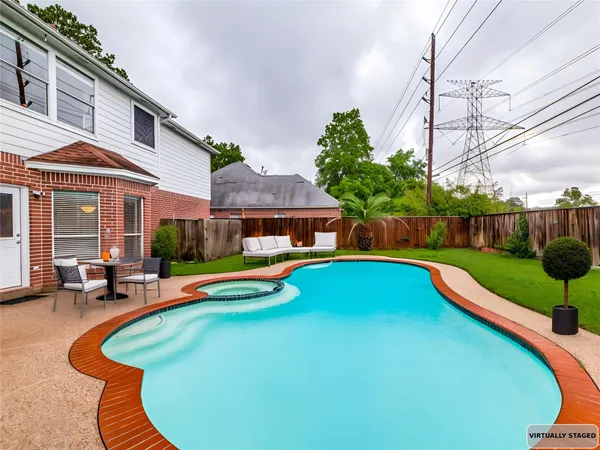 a view of a house with swimming pool and sitting area