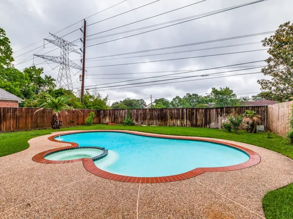 a view of a swimming pool with a yard