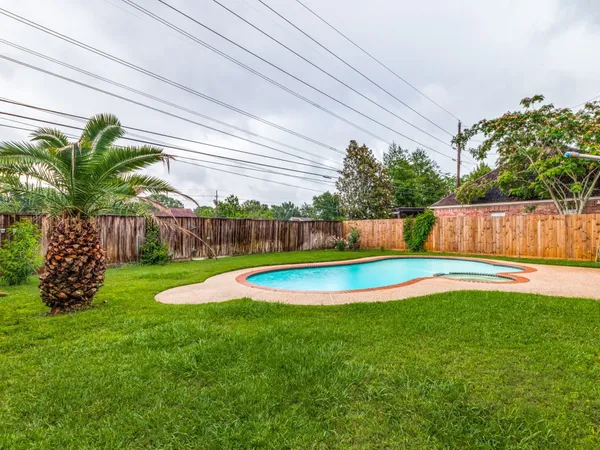 a view of a backyard with a small garden