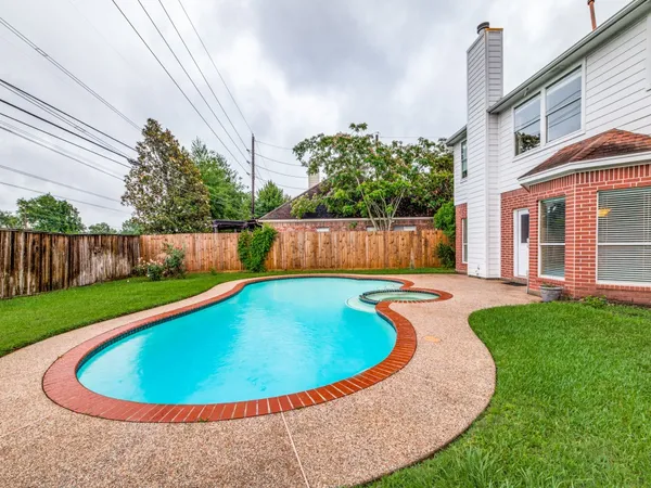 a view of a swimming pool with a patio