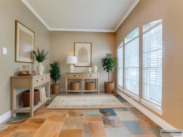 a living room with furniture a fireplace and a potted plant
