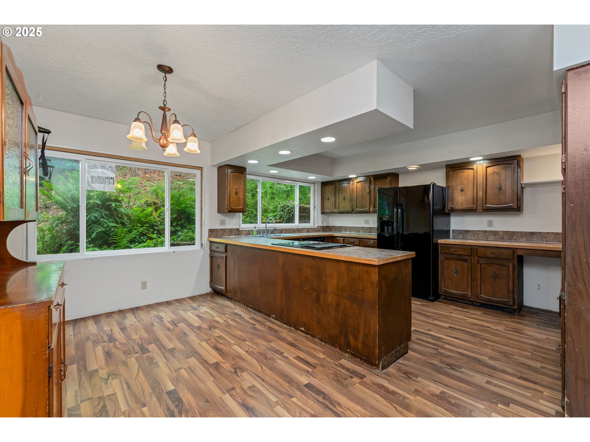 13005 I Street Nehalem, OR 97131 - Photo 14 of 45 a open kitchen with stainless steel appliances granite countertop a stove a sink dishwasher a refrigerator and a fireplace with wooden floor