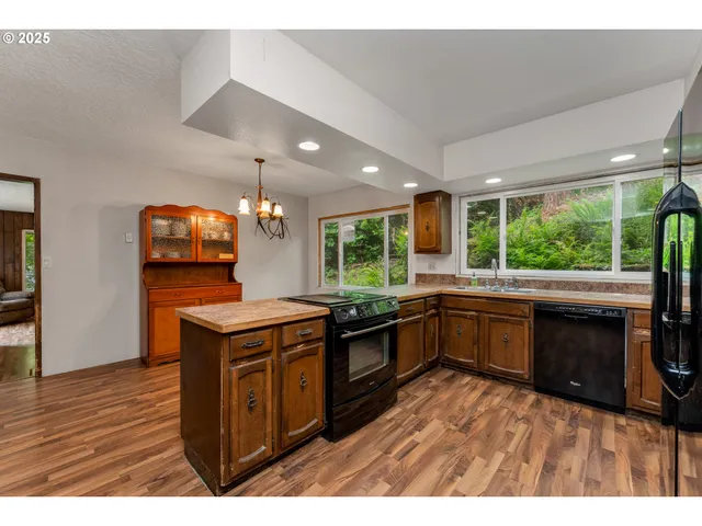 a kitchen with a stove a sink and a microwave