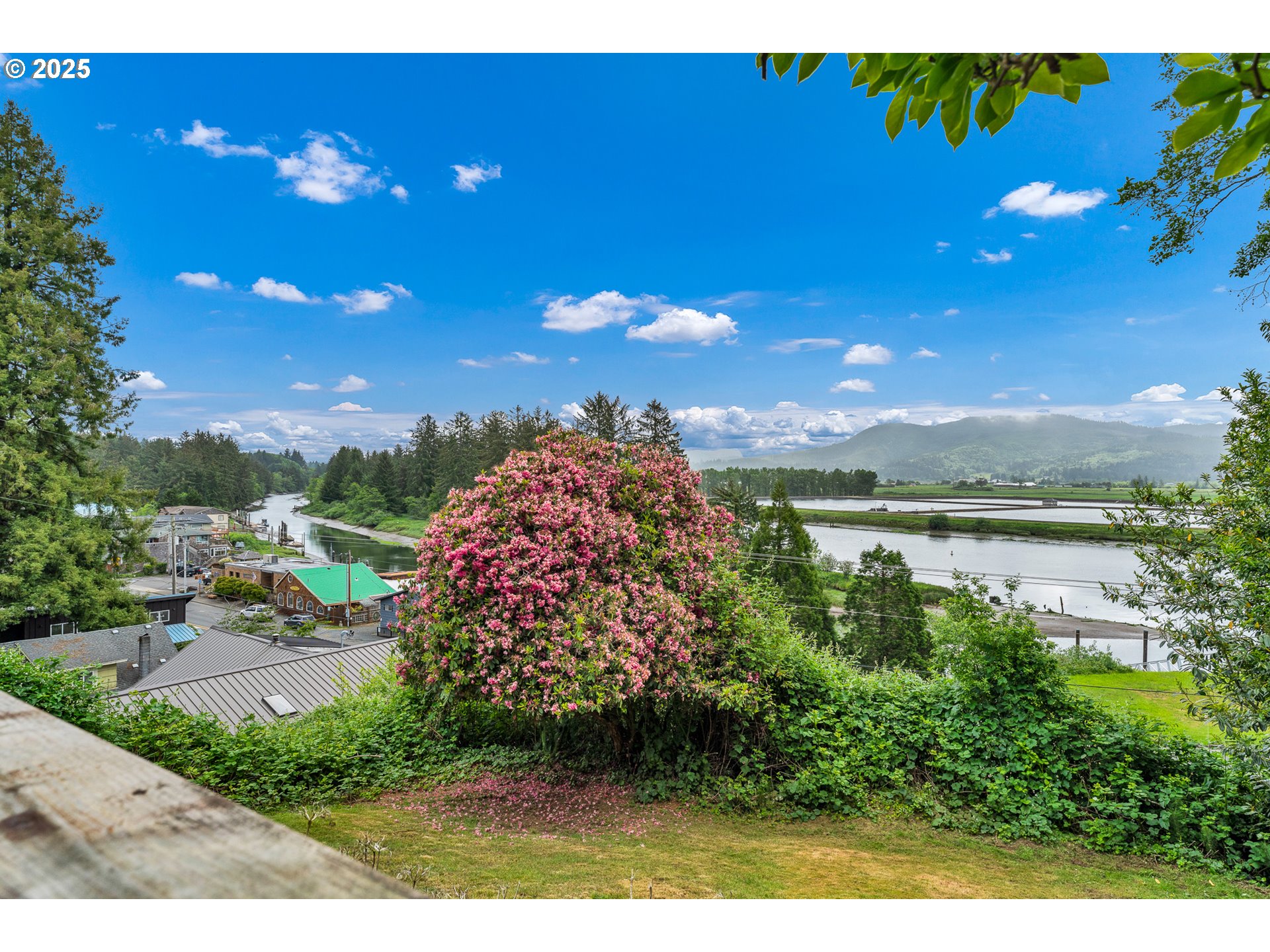 13005 I Street Nehalem, OR 97131 - Photo 21 of 45 a view of a lake with a house in the background