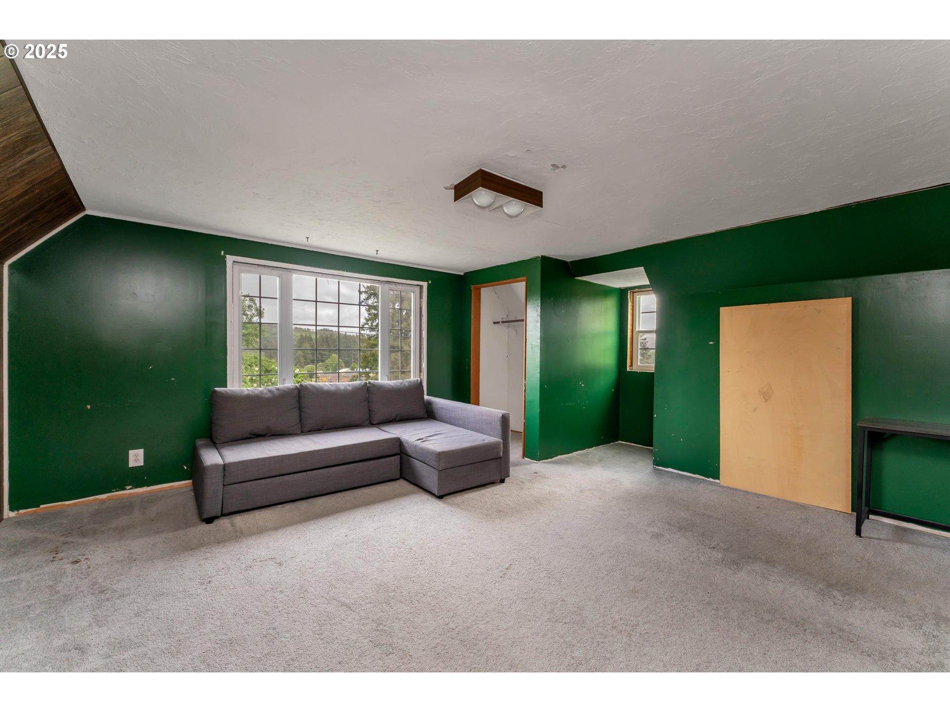 13005 I Street Nehalem, OR 97131 - Photo 23 of 45 a living room with furniture and a large window