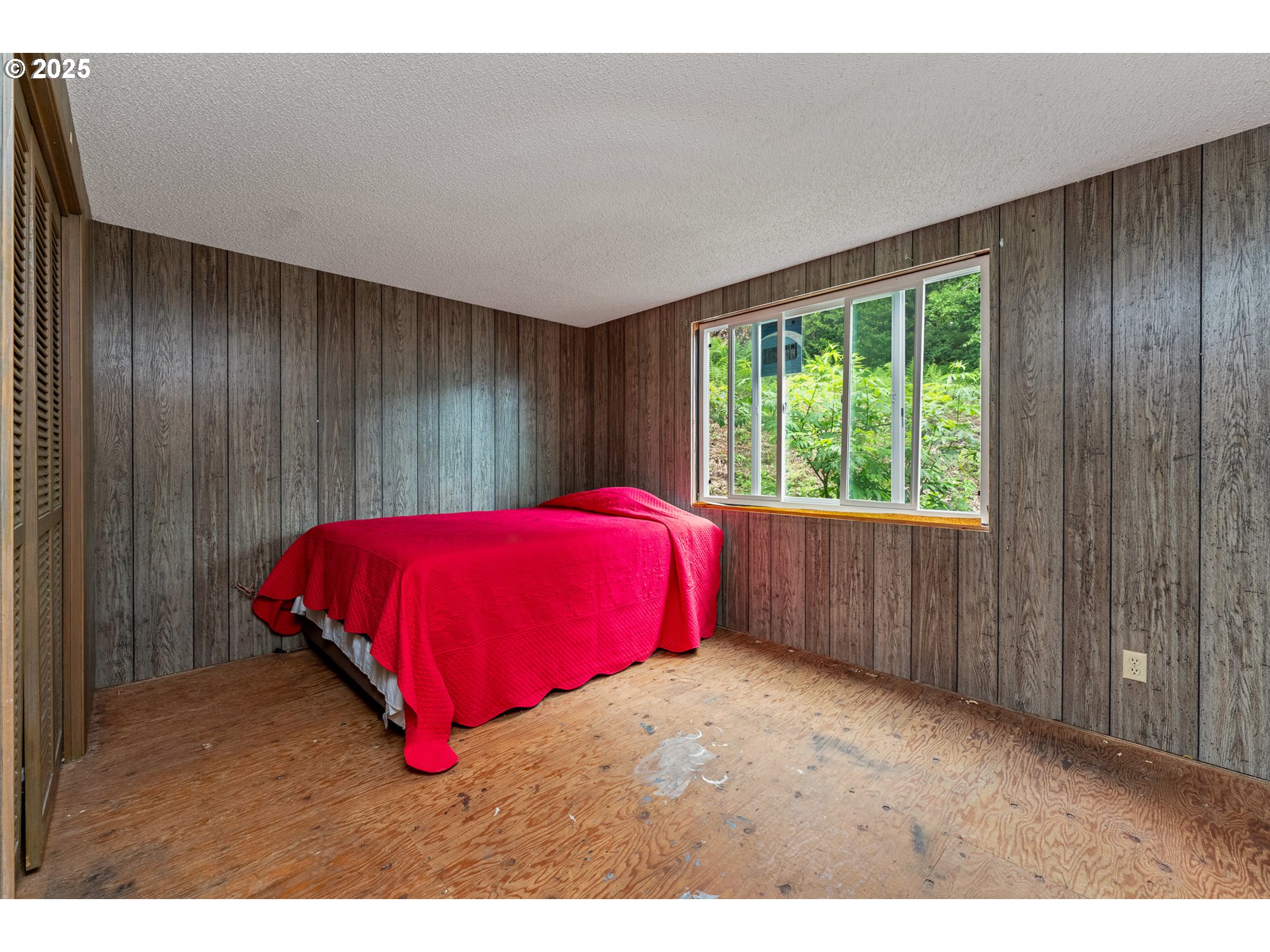 13005 I Street Nehalem, OR 97131 - Photo 25 of 45 a bed sitting in a room next to a window