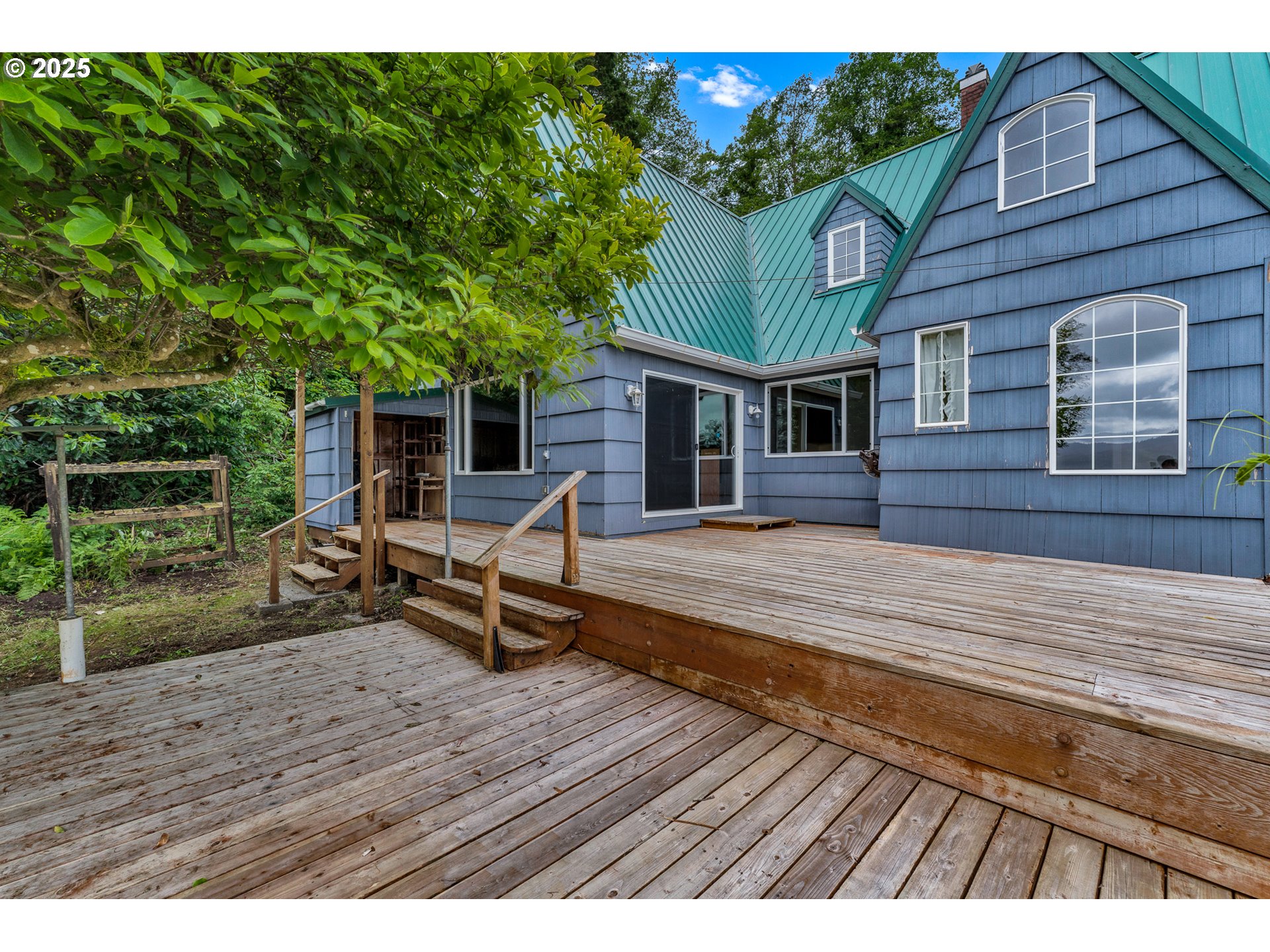 13005 I Street Nehalem, OR 97131 - Photo 30 of 45 a view of a house with wooden deck
