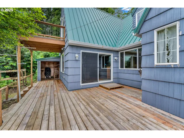 a view of backyard with a deck and wooden floor