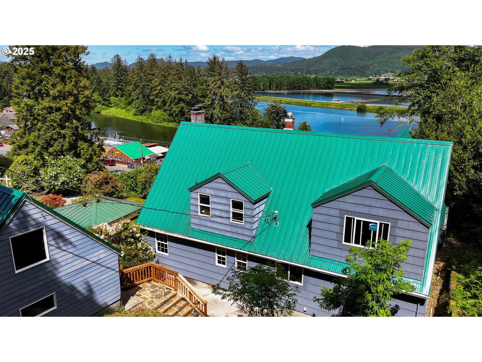 13005 I Street Nehalem, OR 97131 - Photo 40 of 45 a backyard of a house with wooden floor and outdoor space