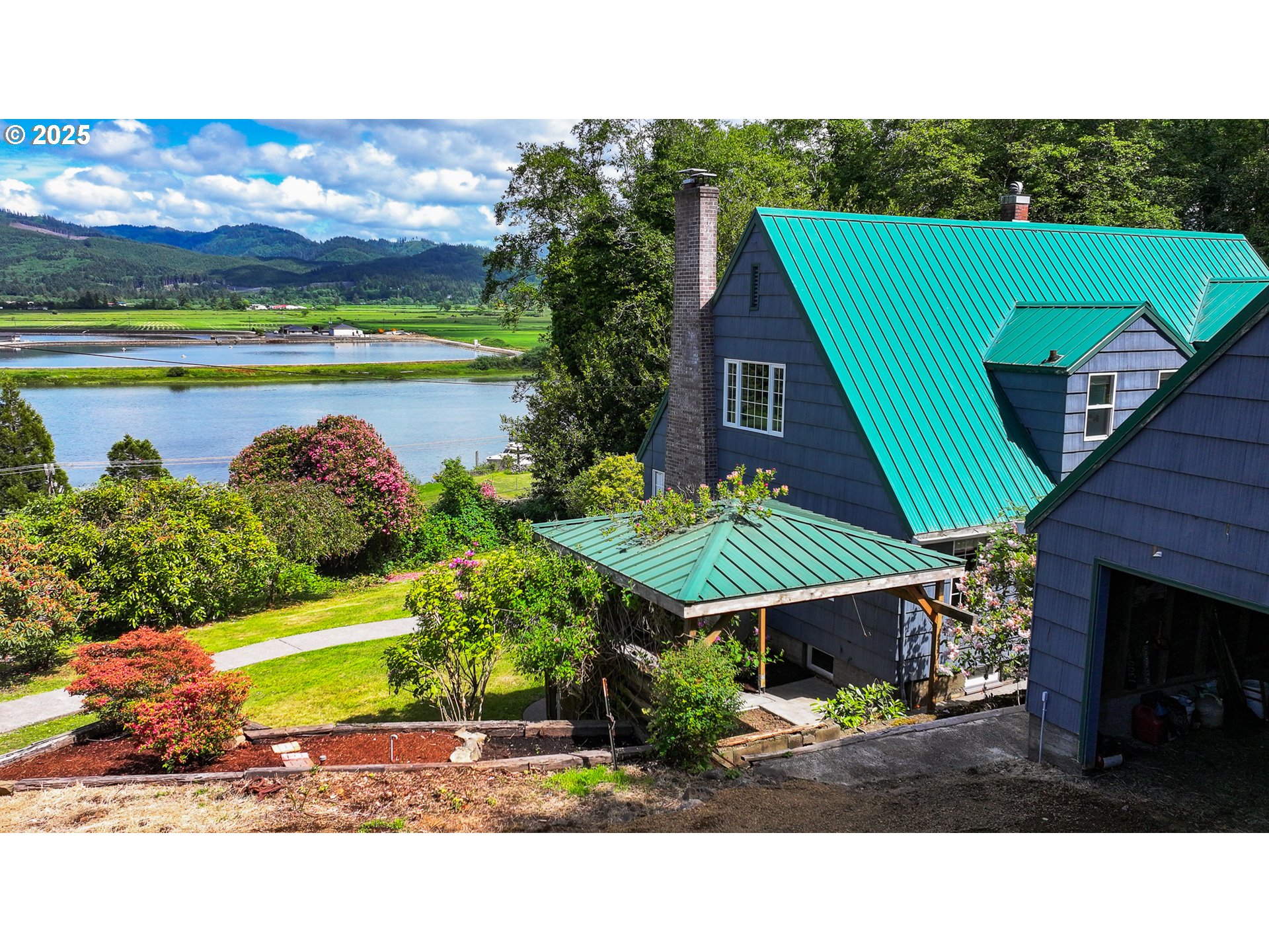 13005 I Street Nehalem, OR 97131 - Photo 43 of 45 a aerial view of a house with a garden and lake view