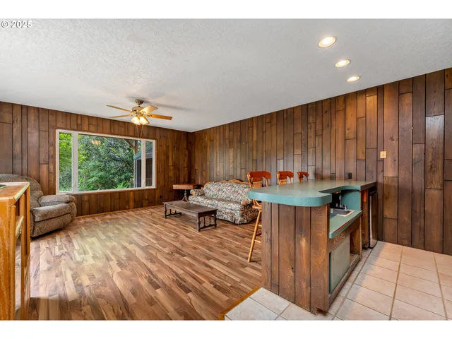 a open kitchen with stainless steel appliances kitchen island granite countertop a refrigerator stove and a sink