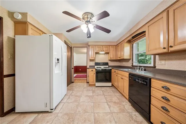 a utility room with a sink dryer and washer