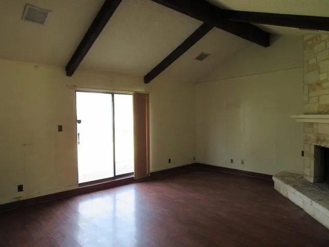 a view of room with window and wooden floor