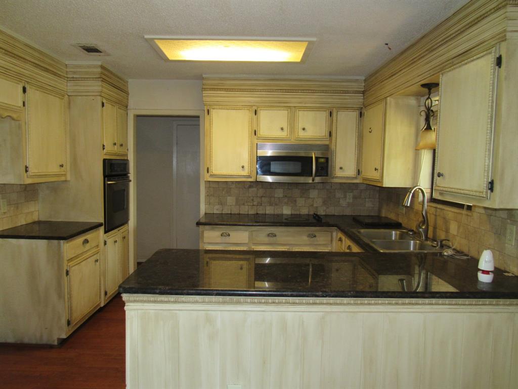 2008 Dan Rowe Street Waco, TX 76704 - Photo 4 of 13 a kitchen with stainless steel appliances granite countertop a sink a stove and a refrigerator