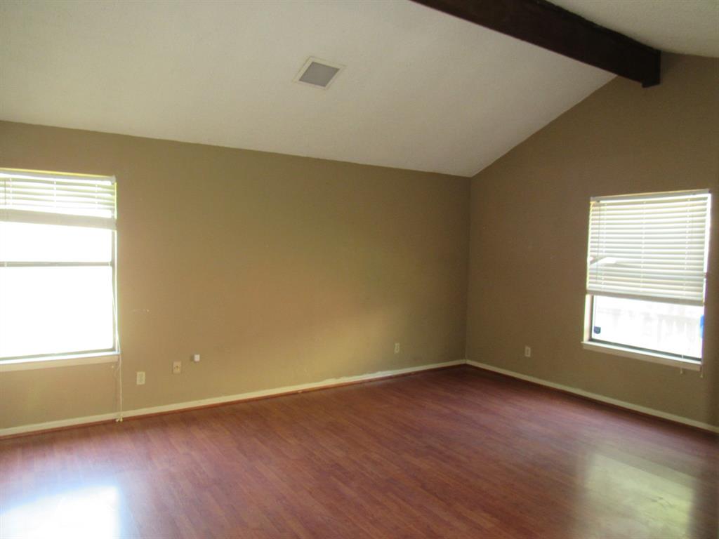 2008 Dan Rowe Street Waco, TX 76704 - Photo 6 of 13 an empty room with wooden floor and windows